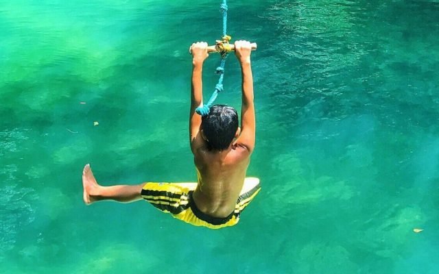 boy on swing into water